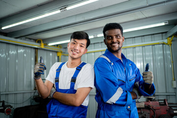 Happy workers in teamwork standing together smiling friendly enjoy working in heavy metal industry. Industrial plant concept.