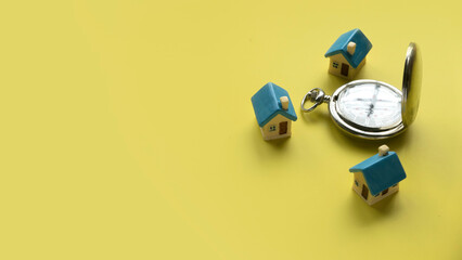 Miniature house and stopwatch. Time to buy a house concept.