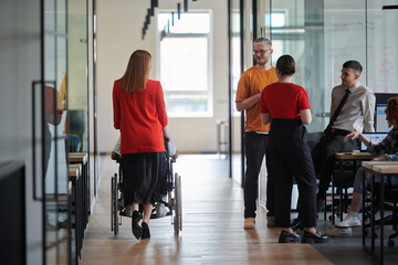 A group of young business people in a modern glass-walled office captures the essence of diversity...