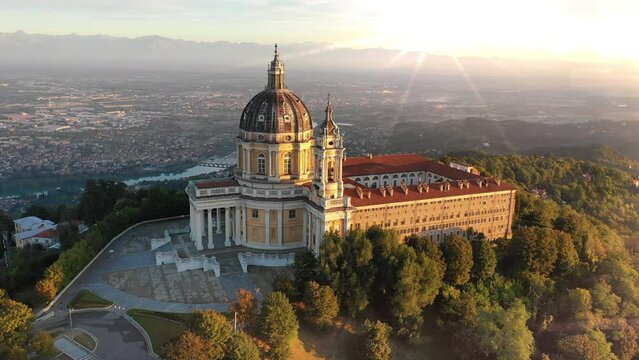 Turin italy city skyline aerial view drone footage fly over cathedral church at sunset.