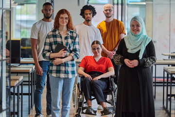 A diverse group of young business people congregates within a modern startup's glass-enclosed office, featuring inclusivity with a person in a wheelchair, an African American young man , and a hijab