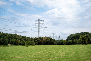 Fototapeta na wymiar power lines in a green field