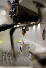 espresso maker pouring coffee into a cup