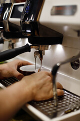 waiter preparing coffee in the espresso machine
