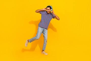 Fototapeta na wymiar Full size portrait of satisfied overjoyed person arms touch headphones dancing good mood isolated on yellow color background