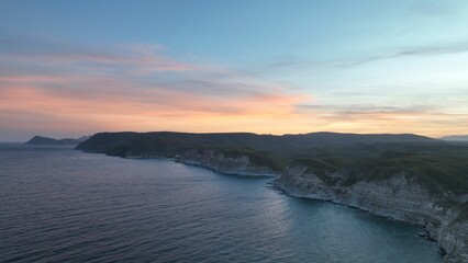 Stunning aerial view of cliffs overlooking the ocean at sunset