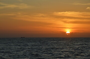 Beautiful golden sunset paints the sky over a serene blue ocean