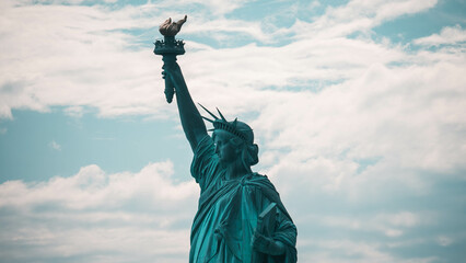 statue of liberty in over cloudy sky