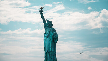 statue of liberty in over cloudy sky