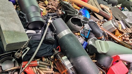 Colour photo of a collection of survival gear piled together on a table