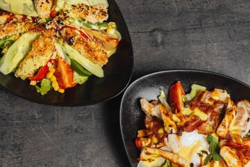 Closeup of a salad topped with chicken nuggets