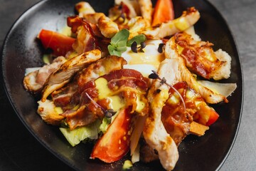 Closeup of a plate of a salad with meat slices