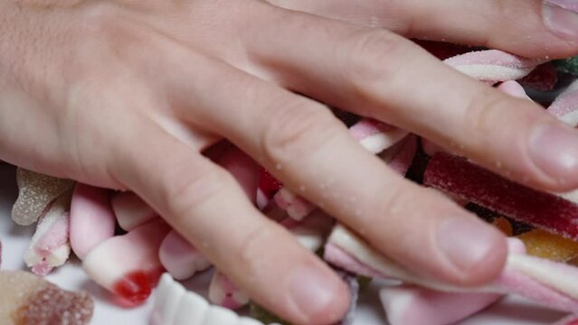 I Take A Handful From The Mix Of Sugar-coated Gummy Candies And Toss It Onto The Table, In Slow Motion.