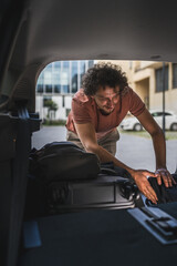 one man travel take stuff belongings from or pack to the back of car