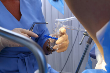 A gynecologist performs a cervical biopsy. Gynecological chair. A woman at the gynecologist for a...