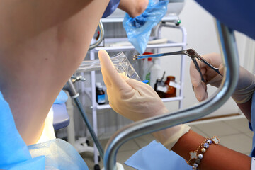A gynecologist performs a cervical biopsy. Gynecological chair. A woman at the gynecologist for a...