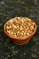 closeup the bunch ripe black gram fried in the wooden bowl soft focus natural brown background.