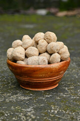 closeup the bunch brown soya bean chunk in the orange wooden bowl soft focus natural brown background.