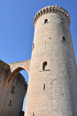 Fototapeta na wymiar Cylindrical Tower Connected to Spanish Castle by Gothic Arch Walkway, Portrait