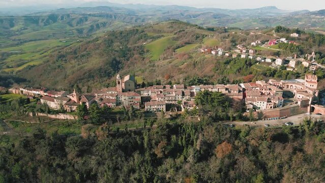 Aerial footage over traditional houses with vegetation trees and lawn in Sinalunga, Tuscany, Italy