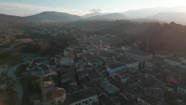 Drone footage over the medieval Mondaino houses in Rimini province, Marche, Italy with hazy sky