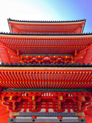 Fototapeta na wymiar Japanese red pagoda. Blue cloudy sky. Temple roof. Oriental architecture. 