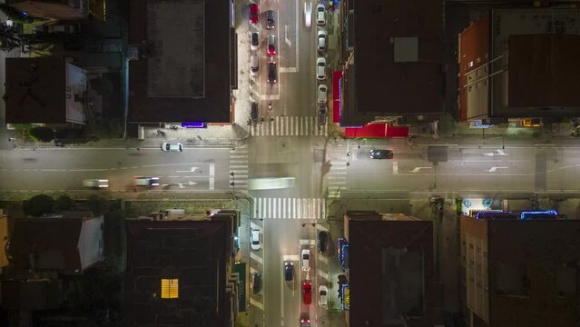 Bied eye hyperlapse footage over road with illuminating cars in a square at night