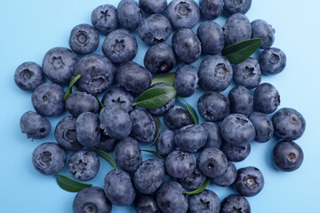 Ripe fresh sweet blueberries on blue background