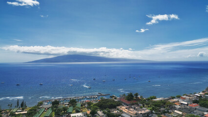 Lahaina from above, in west Maui, Hawaii. With the island of Lanai in the background. Aerial drone image shot April 11, 2023.  The village of Lahaina burned down four months later, on August 8, 2023.