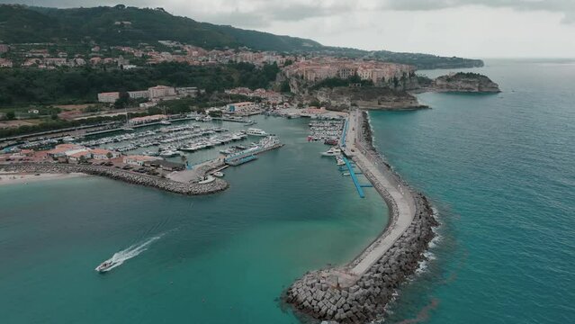 Drone shot over the shore of Tropea Beach and Tonnara di Palmi on a cloudy day