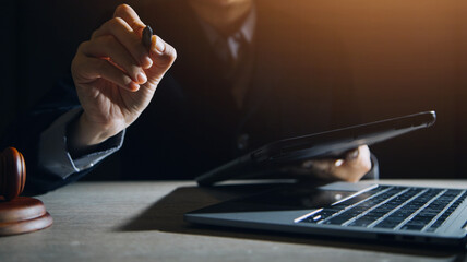 Business and lawyers discussing contract papers with brass scale on desk in office. Law, legal services, advice, justice and law concept picture with film grain effect