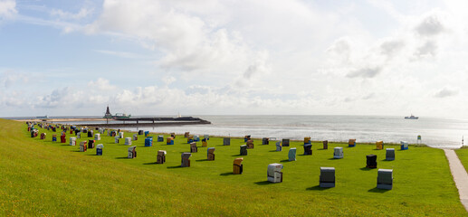 Panoramic photo of the coast of Cuxhaven Lower Saxony, Germany. Beach baskets on the North Sea