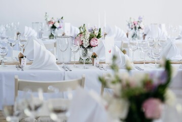 a group of dining tables set up in the middle of a room
