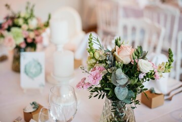 there is a table set with two vases of flowers
