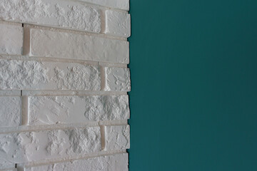 Background made of white natural brick, contrasting with the wall