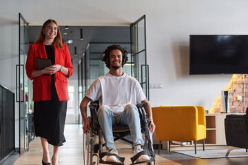 A group of young business people in a modern glass-walled office captures the essence of diversity...