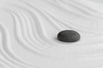 Zen Garden with Grey Stone on White Sand Line Texture Background, Top View Black Rock Sea Stone on Sand Wave Parallel Lines Pattern in Japanese stye, Simplicity Day, Meditation,Zen like concept.