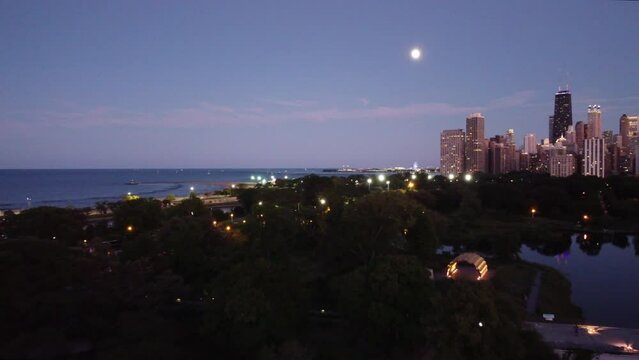 Dusk over Lincoln Park Zoo flying towards the Magnificent Mile in Chicago