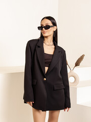 Woman in black oversize jacket. Clothes for office, school, work. Classic modern style