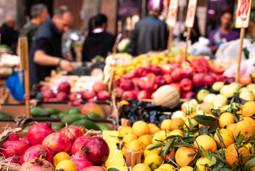 Fruit and vegetable stall in a street market in Naples in Italy. Signs with prices in the...