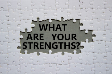 What are your Strengths symbol. White puzzle with words What are your Strengths. Beautiful grey...