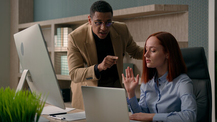 Annoyed African American businessman argue with Caucasian businesswoman angry furious ceo boss...
