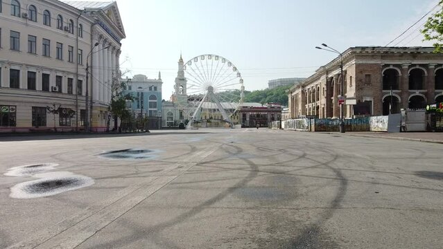 Empty city - puddle reflection - Podil in Kyiv, Ukraine near ferris wheel