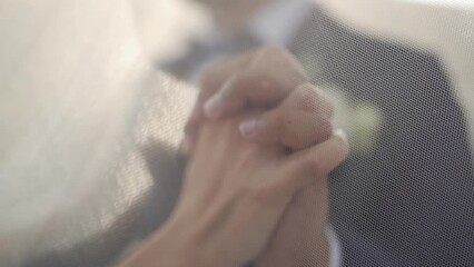 Closeup slow-motion on bride and groom hands holding each other romantically in their wedding day