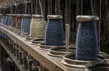 string spools of a historic  weaving machine - obrazy, fototapety, plakaty
