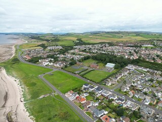Aerial view of a residential area with lush green grass in Scotland