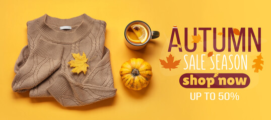 Stylish sweater, cup of tea, pumpkin and autumn leaf on color background