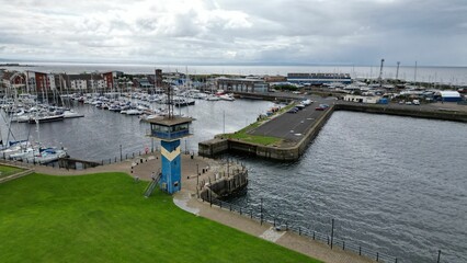 Aerial shot of a bustling pier, during cloudy weather in Scotland