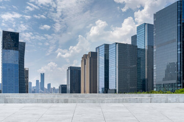 empty concrete floor with modern office buildings and skyline in the downtown street.