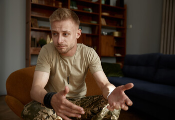 Portrait of sad military man telling about his problem looking aside